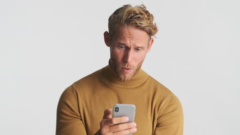 Concerned and happy man using smartphone