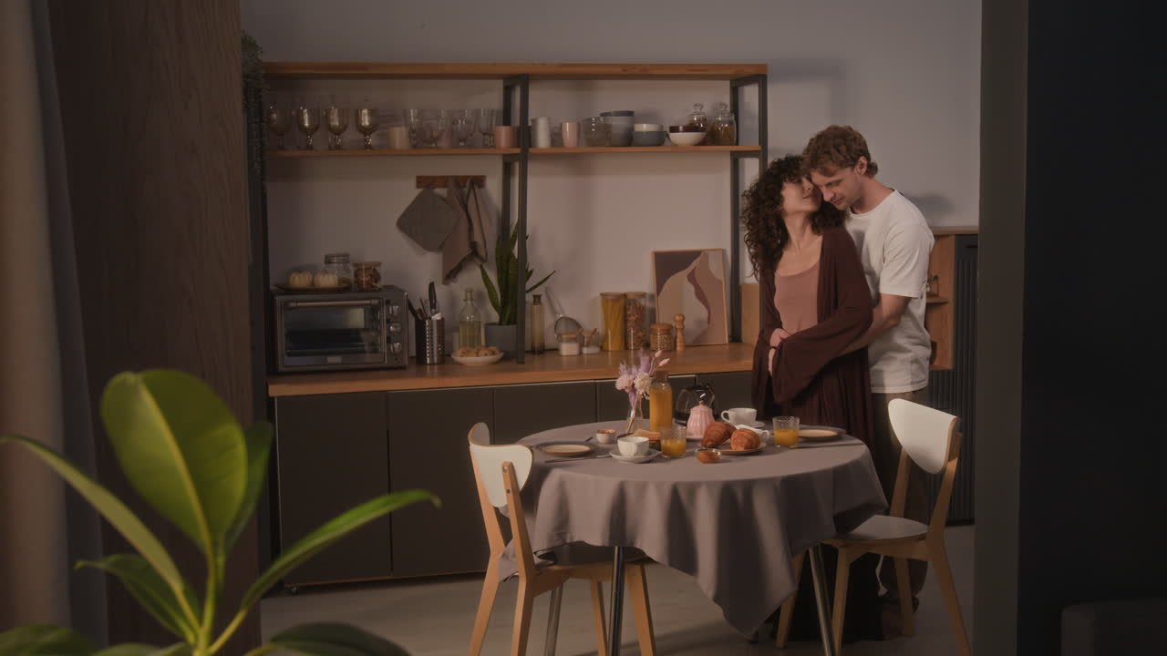 A couple having breakfast together in the kitchen