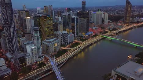 aerial view of brisbane city cbd riverside with highway passing by at night