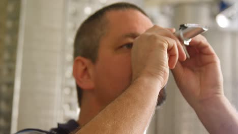 Male-worker-using-magnifying-glass-4k