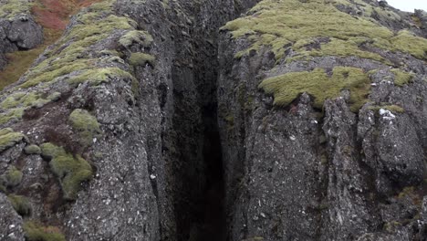 entrance of famous lambafell crevasse in volcanic landscape of iceland