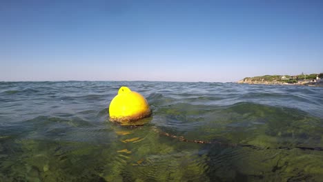 yellow buoy sways, swaying in the ocean waves