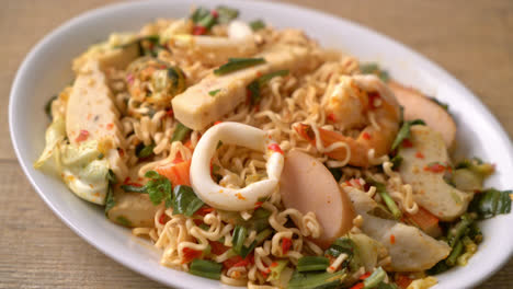 instant noodle spicy salad with mixed meats - asian food style