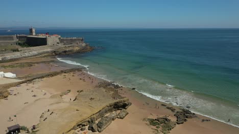 aerial drone view of sao joao fort in carcavelos beach, lisbon, portugal