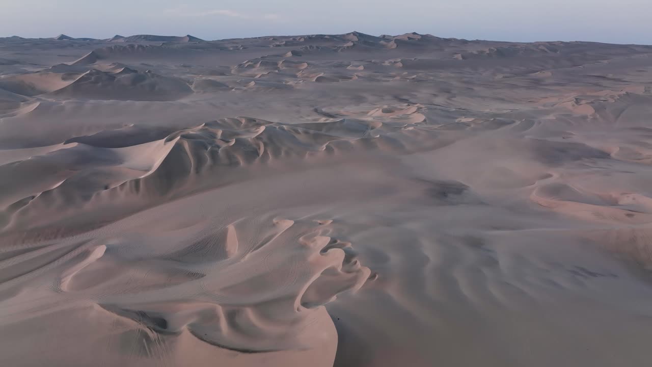 vista aérea de un dron volando sobre las enormes dunas de arena del desierto al amanecer