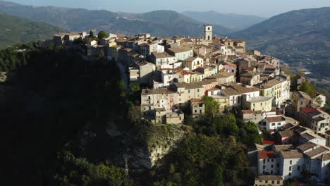 Left-orbiting-aerial-shot-of-hilltop-old-town-Trivento-in-Molise-region-in-Italy