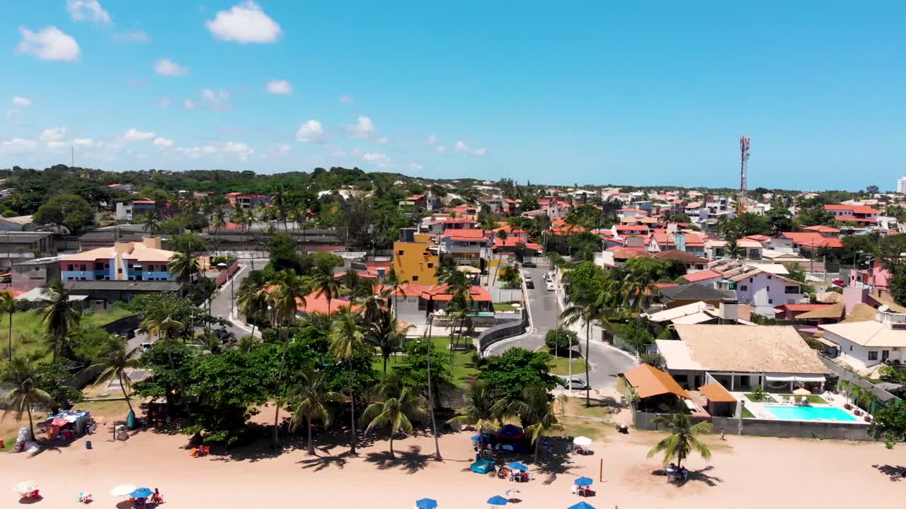 Aerial View of Tropical Coastal Town with Beach