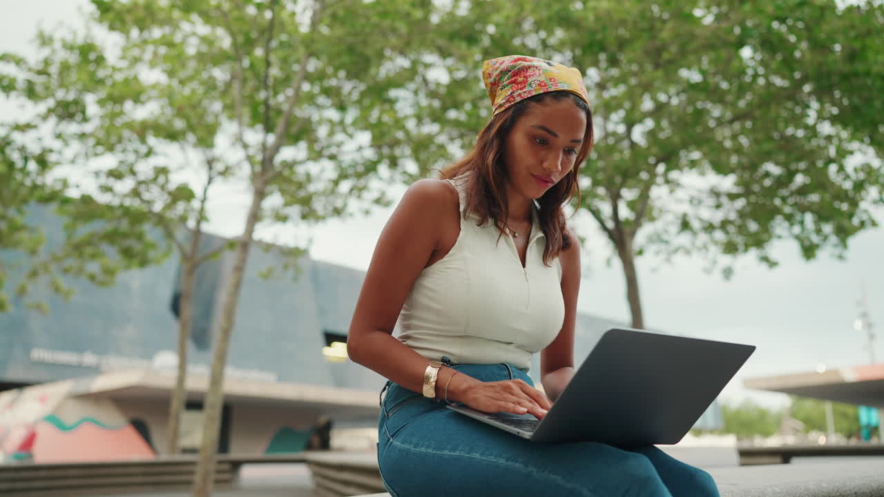 Woman using a laptop outdoors