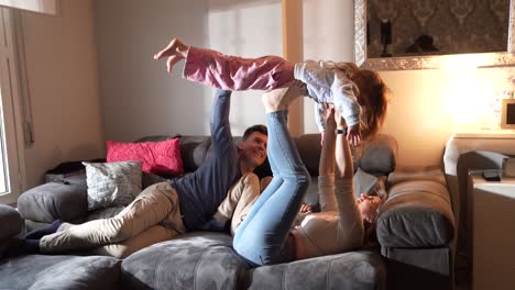 family playtime: parents and child having fun on the couch
