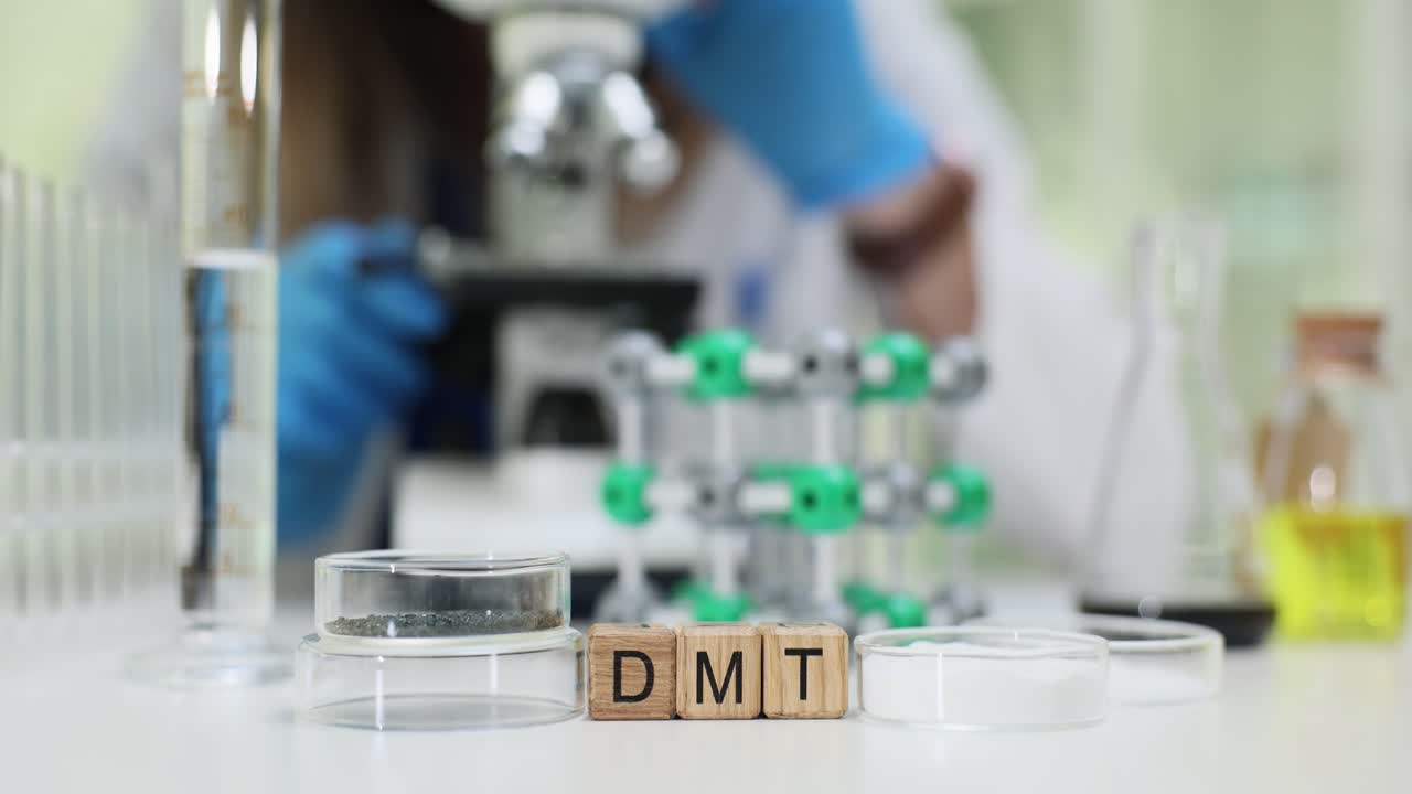 DMT Blocks on Lab Table with Scientist Using Microscope