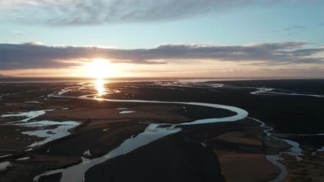 4k drone video of sunrise over a river delta in iceland