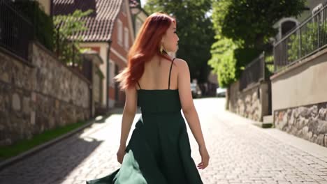 a confident woman in a flowing green dress strolls through a charming cobblestone street, embracing the beauty of her surroundings and radiating style
