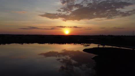 reflection of the sun in the lake at sunrise