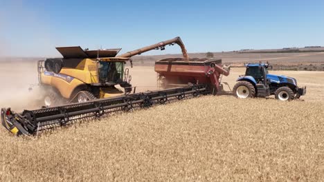 This-footage-captures-the-synergy-of-modern-agricultural-technology,-showcasing-the-essential-role-of-header-fronts-in-the-wheat-harvesting-process