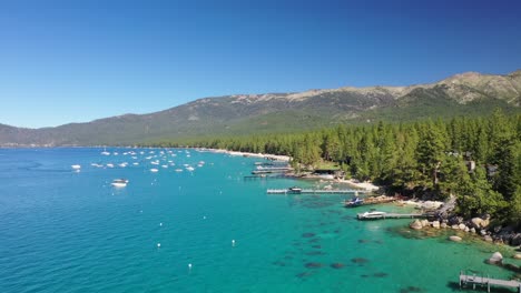 Aerial-View-Of-Boats-Near-Shore-Of-Lake-Tahoe,-California,-USA---drone-shot