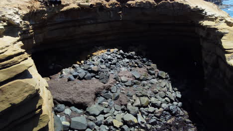 Caves-of-Sunset-cliffs-in-San-Diego,-aerial-orbit-drone-view