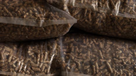 slider shot of bags of wood pellets stacked on each other, for use as an eco-friendly renewable organic biofuel or mulch in the garden