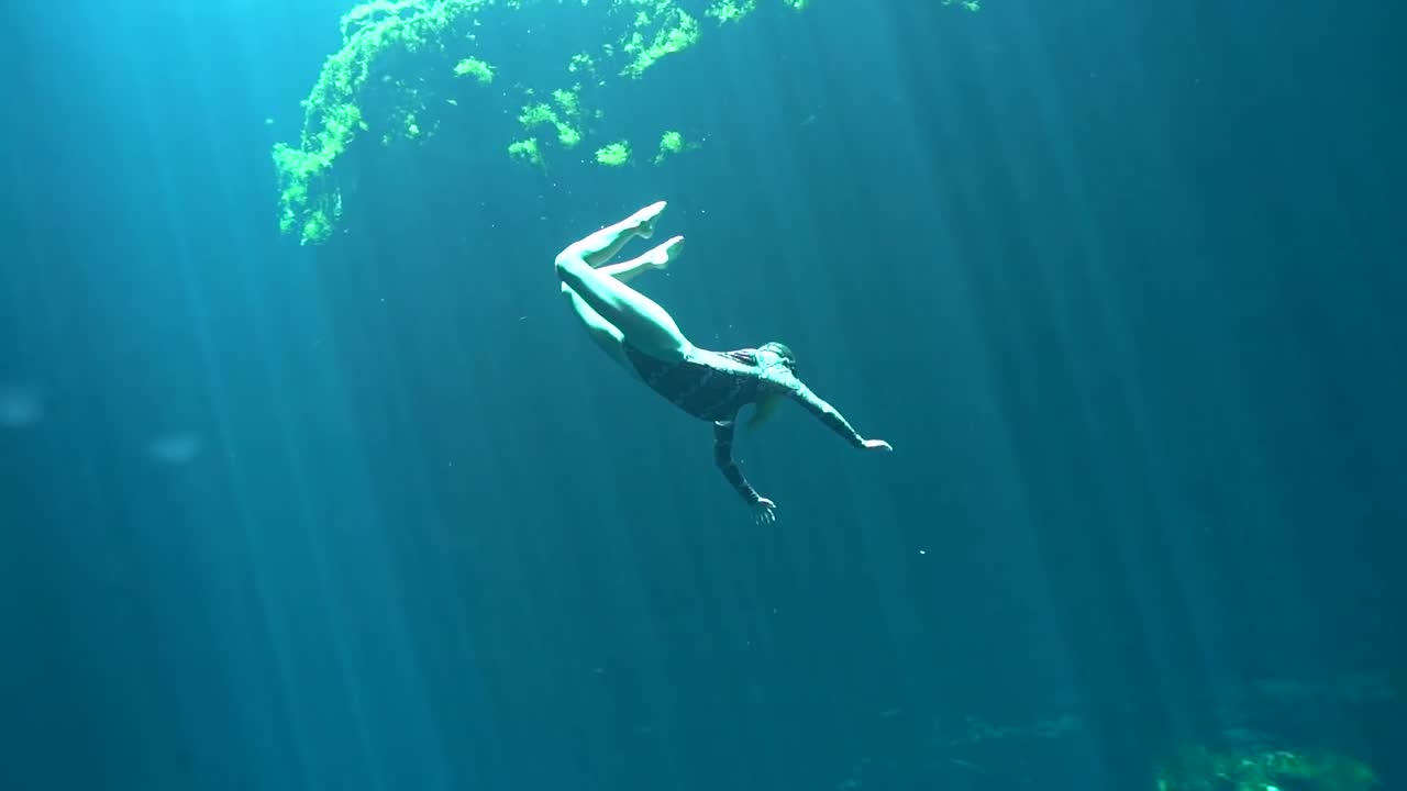 Woman Freediving in a Cenote