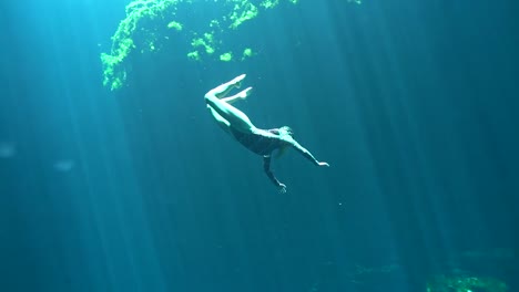 woman freediving in a cenote
