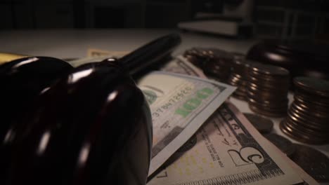 judge gavel dollars and coins on table