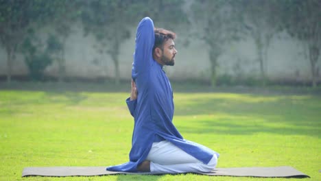 cow face yoga pose performed by an indian man