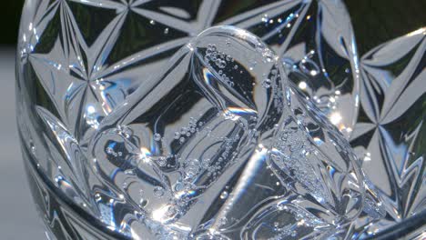 ice in a cut glass with bubbles