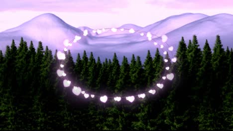 animation of fairy light frame with copy space over fir trees and winter scenery