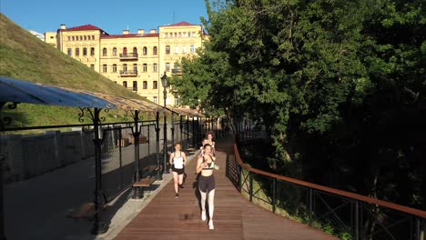 women running in a city park