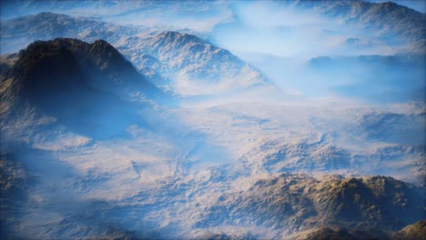 distant mountain range and thin layer of fog on the valleys