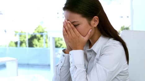 businesswoman feeling stressed at her desk