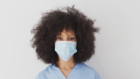 Young-woman-wearing-face-mask-against-white-background