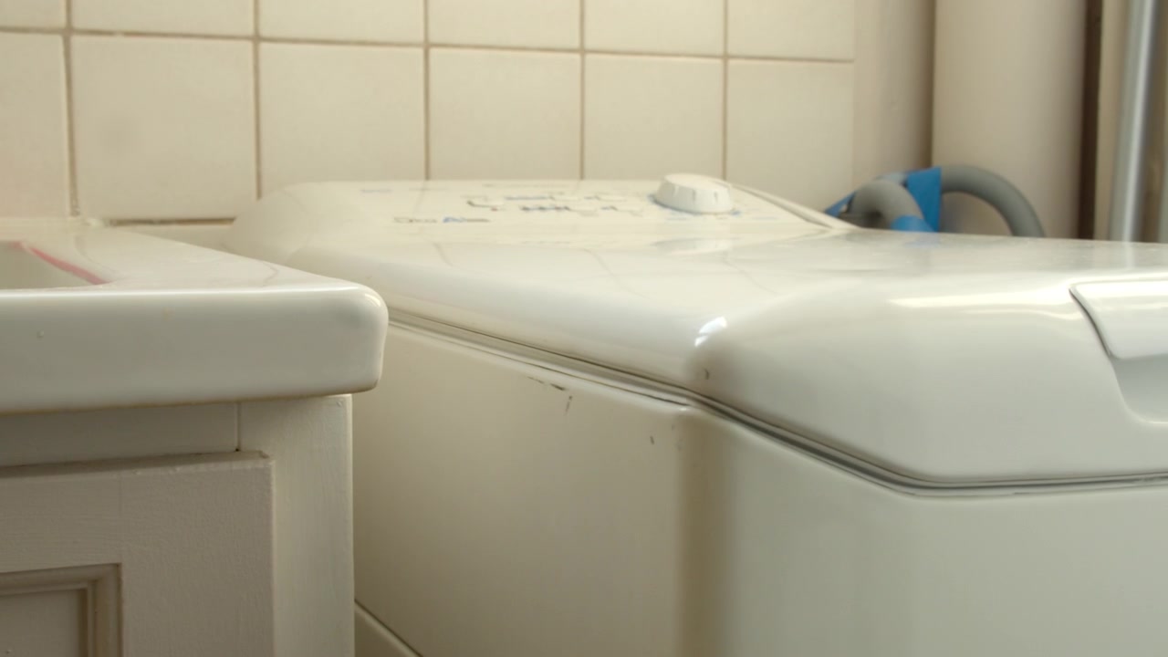 Working Indoor Washing Machine In A Residential Laundry Area. Close-up Shot