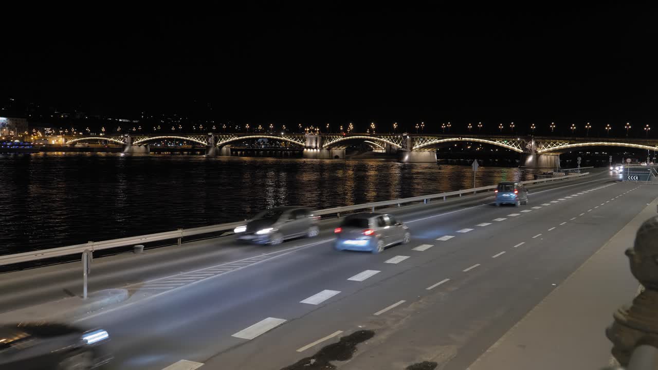 Budapest, Hungary, illuminated Margaret bridge at night. Reduced traffic due to coronavirus covid-19 outbreak