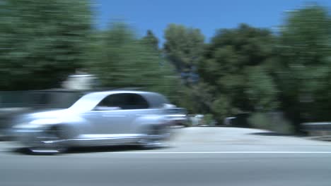 a car travels along a scenic highway near los angeles california as seen through the side window 1