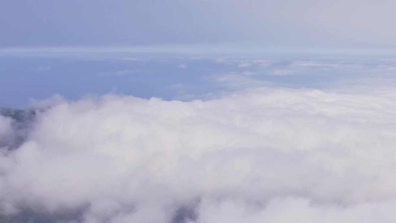 Stunning aerial view of misty clouds over Madeira, Portugal coast