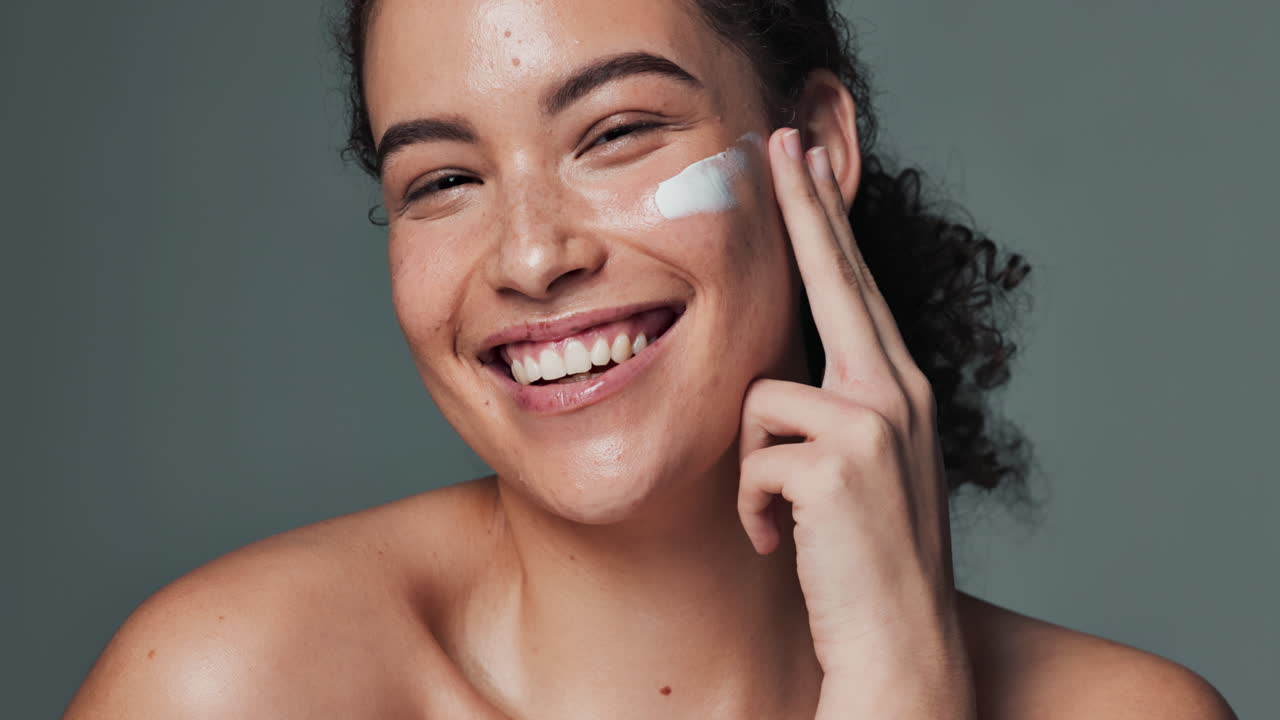 Woman applying skincare cream to her face