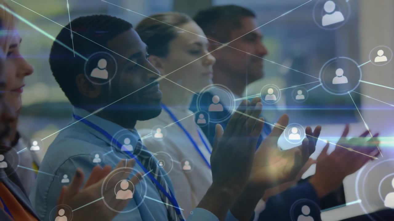 Animation of network of people icons over happy diverse business people clapping hands