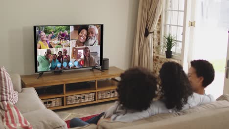 African-american-family-having-a-video-call-on-tv-while-sitting-on-the-couch-at-home