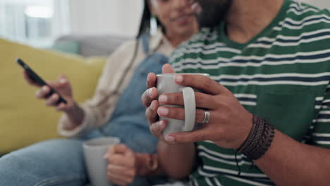 Hands,-coffee-and-phone-with-couple-on-sofa