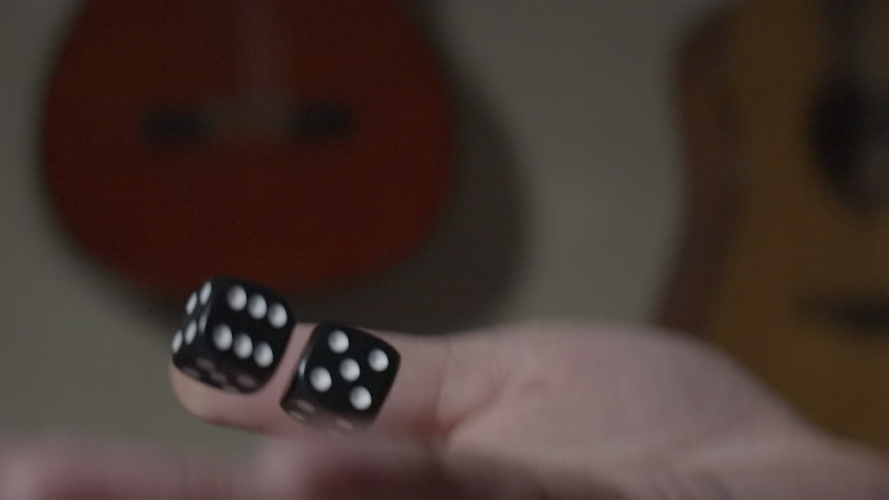 Slow motion dice thrown into the air by hand