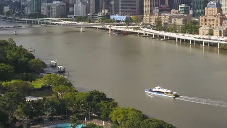 High-angle-aerial-dolly-above-Brisbane-river-as-ferry-transports-commuters