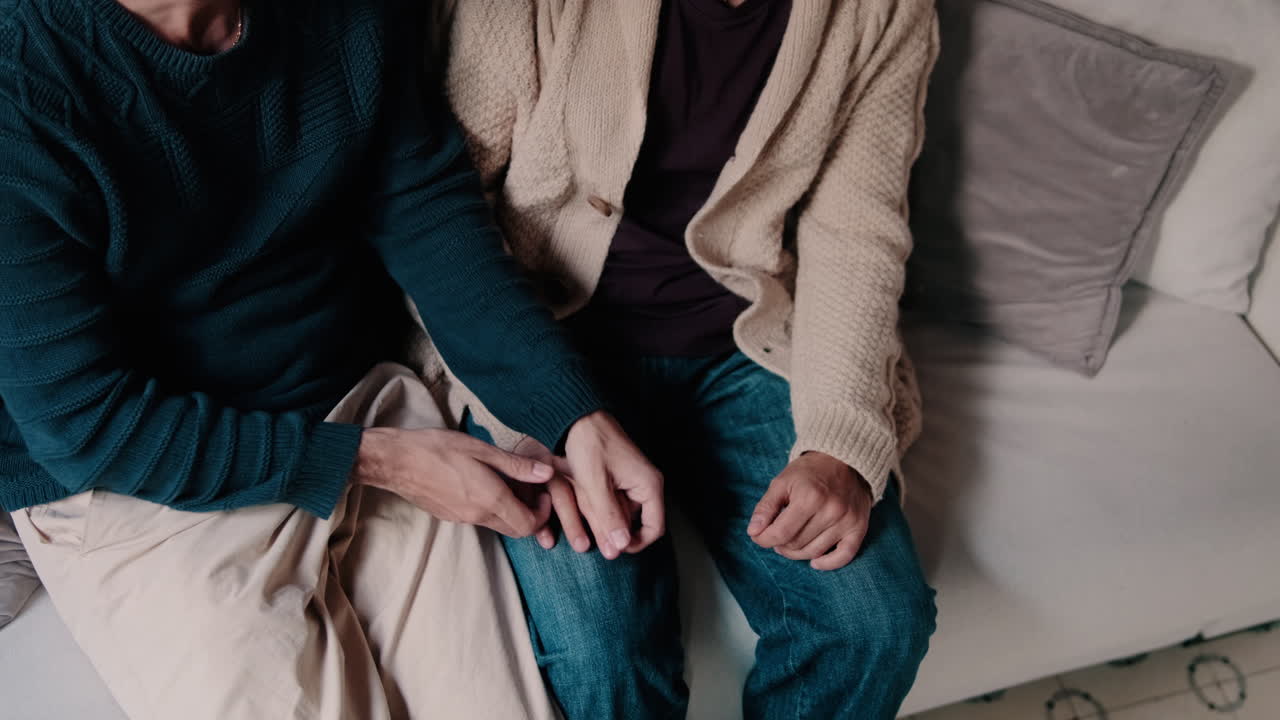 Gay Couple Holding Hands at Home