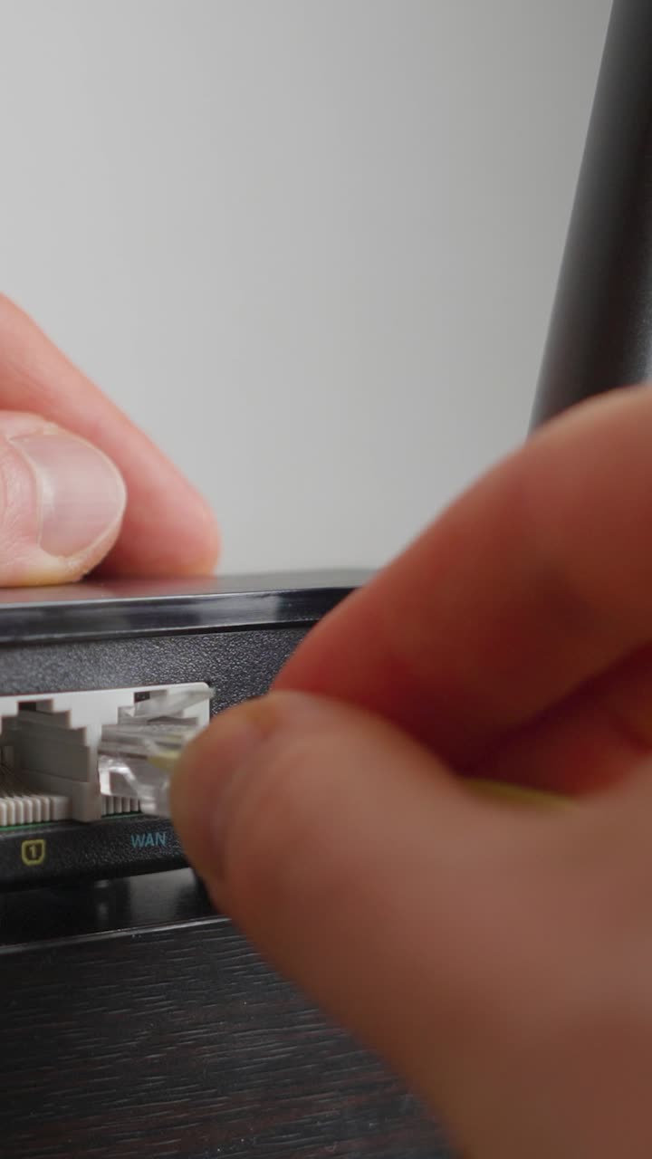 Man plugging in a WiFi router. Extreme close up