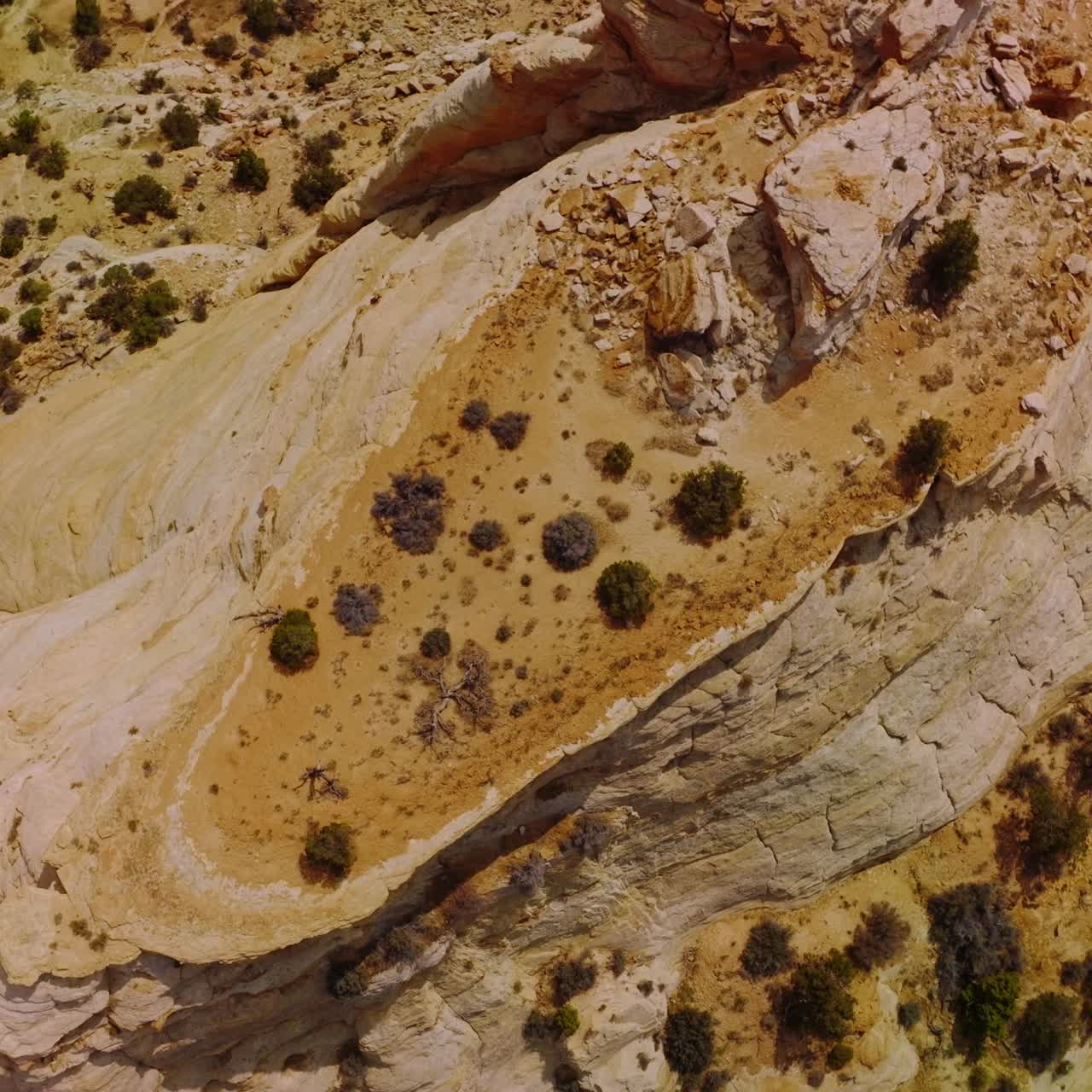 Dry and lifeless landscape of deserted territories in National Park of Utah, USA. Circle drone footage over the rock lit with bright hot sun