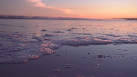 Abstract-Texture-Of-Foamy-Bubbles-Washing-On-Shoreline-During-Sunset