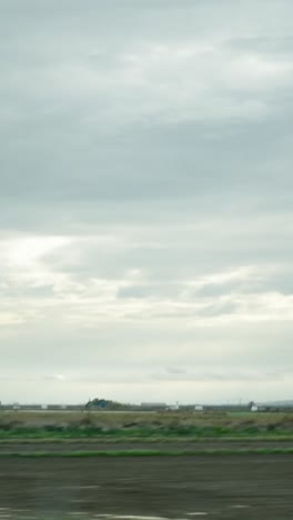 A view of a field under a cloudy sky