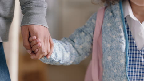 father holding daughters hand taking little girl to school