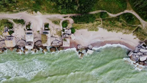 historic artillery bunkers collapsing on the baltic coastline, a remnant of war