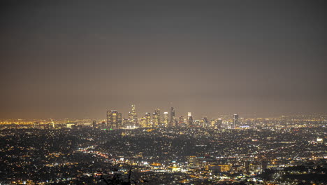 lapso de tiempo aéreo de la hermosa iluminación de los ángeles por la noche - hermoso horizonte y aviones volando en el cielo