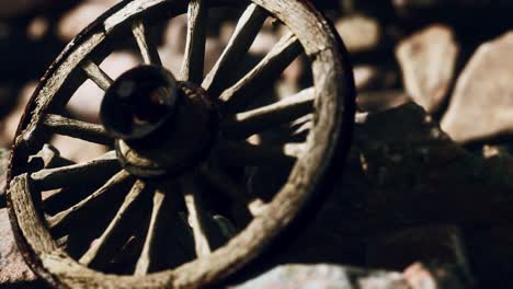 old-wooden-wheel-on-rocks